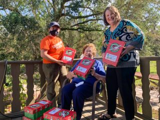 Lula (center) and her daughter Kathy celebrate the packing of Operation Christmas Child shoebox gifts with Samaritan’s Purse  disaster relief volunteer Joslyn Baergen. 
