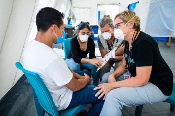Physicians Assistant Gwen Miller and Nurse Kathy Mazzella share the Gospel through a translator with Israel at our Emergency Field Hospital.