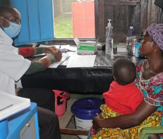 A patient and her child meet for a consultation with medical personnel at the clinic in Shari, DRC.