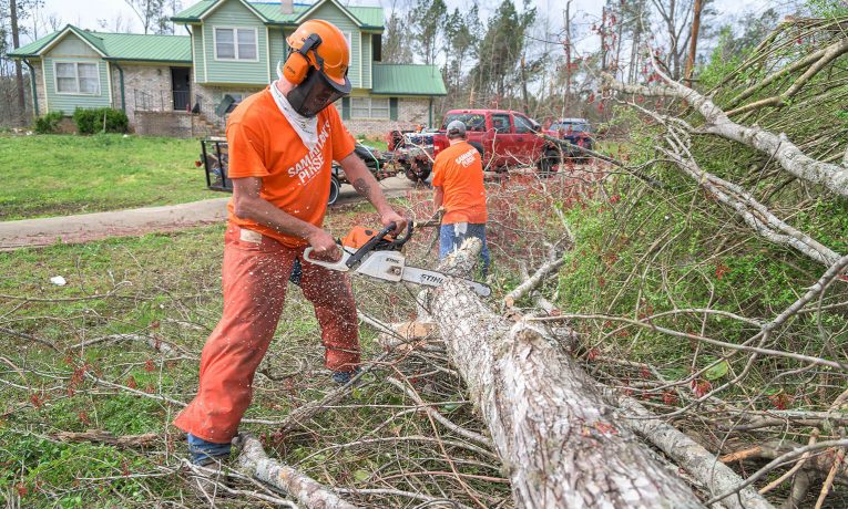 Volunteers cut up and haul away downed trees near Gadsden, Alabama.