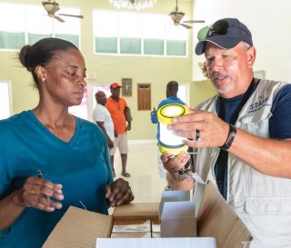 Bryan Babcock helps distribute solar lights to victims of Hurricane Dorian.