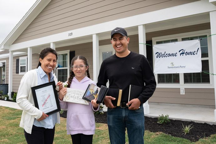 Leticia Jaimes, her daughter Daniela, and Leticia's brother David celebrate the new home in LaGrange, Texas.