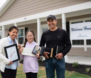 Leticia Jaimes, her daughter Daniela, and Leticia's brother David celebrate the new home in LaGrange, Texas.