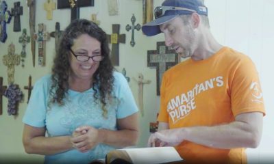 Samaritan’s Purse volunteer presents Bible to homeowner