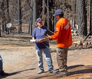 Samaritan's Purse volunteers provide a special Billy Graham Study Bible for a homeowner.