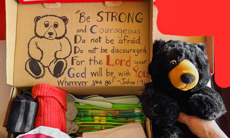 Theresa Bell themed this shoebox around camping with a picture of a deer on the outside and a stuffed bear, an animal t-shirt, and a water bottle inside.
