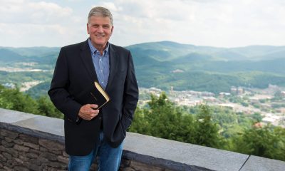 Franklin Graham holding a Bible and smiling