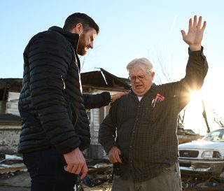 Edward Graham prays with Tommy Anderson, a long-time member of his community.