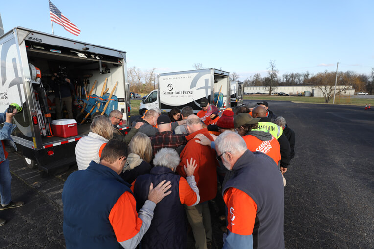 Volunteers pray before each day's work in Mayfield.