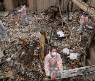 Samaritan's Purse volunteer teams sift through the ashes of what used to be Karla Bennett's home.