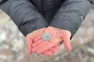 Though charred and stained an ashen hue, volunteers recovered a precious coin passed down through generations.