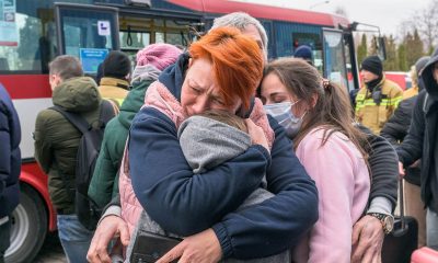 family hugging, taken from Poland on Ukraine border