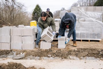 Students help prepare the foundation for Treva's  new home.