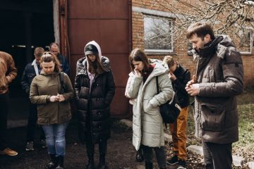 A local pastor named Benjamin prays over Samaritan's Purse staff and his congregration of volunteers before a day of distributions in Ukraine.