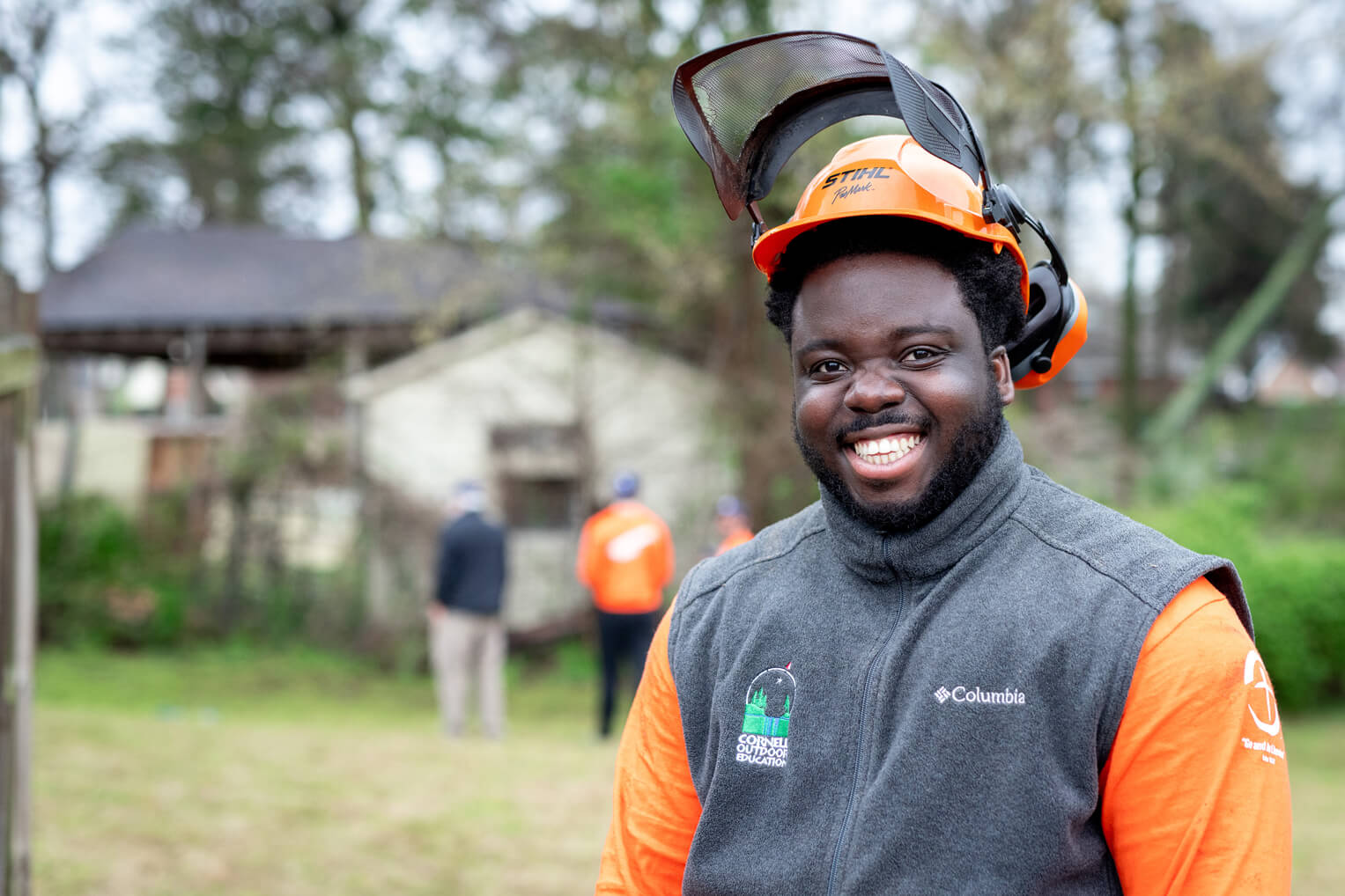 Recent Cornell University graduate Glenn Asuo-Asante joined students in Memphis where he applied chainsaw skills to clear trees from a yard.