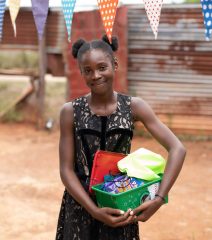 Chadelfa received a gift-filled shoebox at an outreach event in Drepada. 