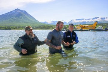 Army Sergeant Sean Karpf emerges after being baptized in Lake Clark.