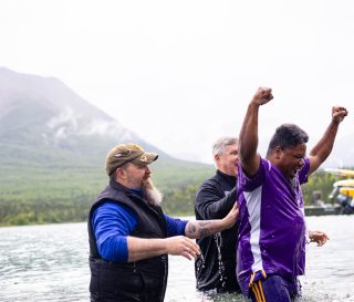 Air Force Master Sergeant Jameel Beasley celebrates after his baptism in Lake Clark.