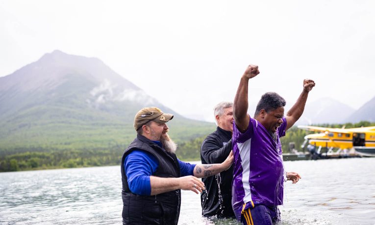 Air Force Master Sergeant Jameel Beasley celebrates after his baptism in Lake Clark.