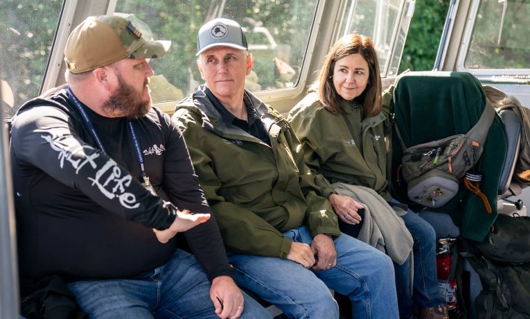 Former Vice President Mike and Karen Pence speak with a wounded veteran, John Barry