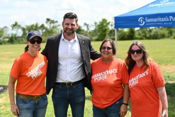 Edward Graham, vice president of operations at Samaritan's Purse, joins volunteers in celebrating Thomas Woodward's new home.