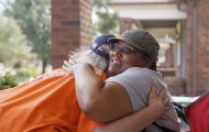 Helping homeowners in St. Louis County, Missouri. Volunteer gives homeowner a hug.