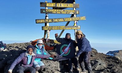 The Cooks reach the top of Mt. Kilimanjaro, highest peak in Africa.