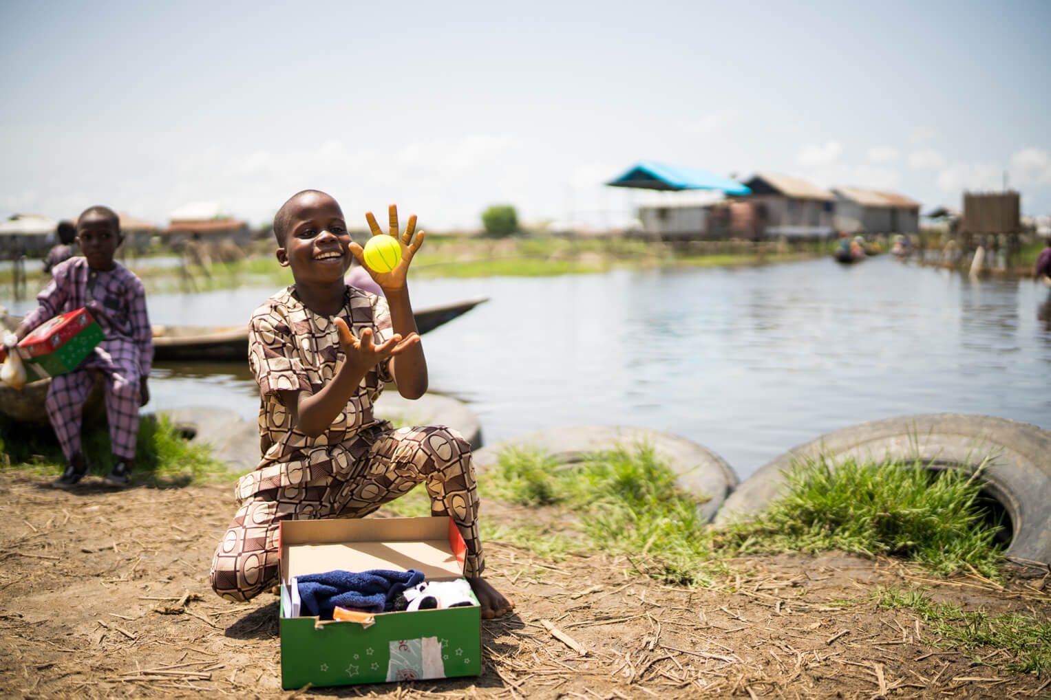 A boy enjoys a new item that he received in his shoebox gift.