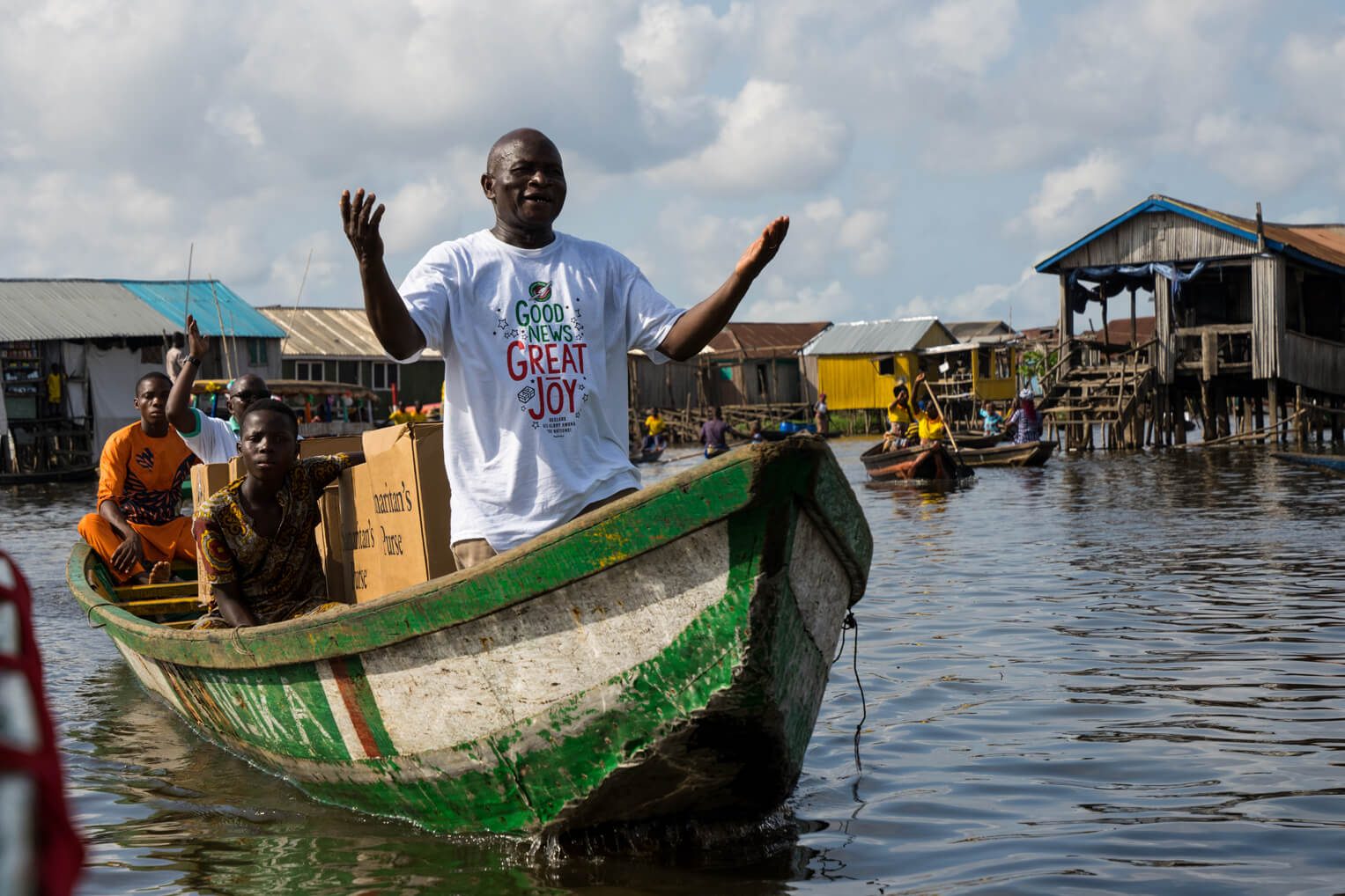 Operation Christmas Child volunteers in Benin transport shoebox gifts across Nokoue Lake west of the capital Cotonou.