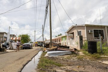 Many are without power and water in Puerto Rico. Flooding caused much damage, and waterlogged items line neighborhood streets.