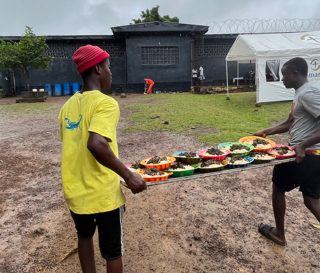 Inmates help prepare food for other inmates during a Samaritan's Purse outreach at Liberia's Central Prison.