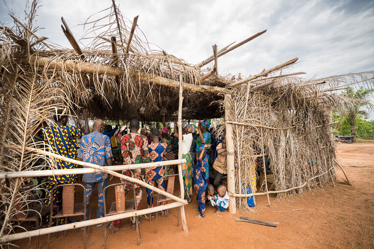 Many people attend services in a thatch hut constructed in a field donated by the village leaders.