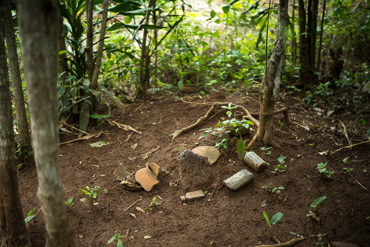 Broken pots and other artifacts in a grove of trees marks the trail leading to Ogouleroun's home.