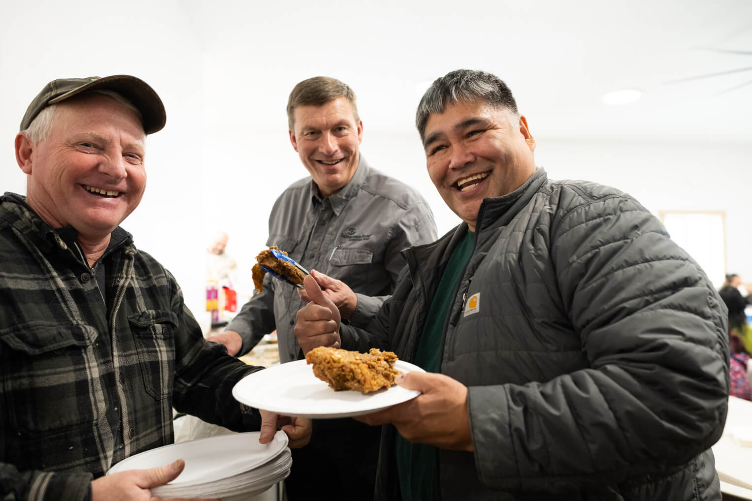 Luther Harrison, vice president of North American Ministries, enjoys potluck with men in the village.