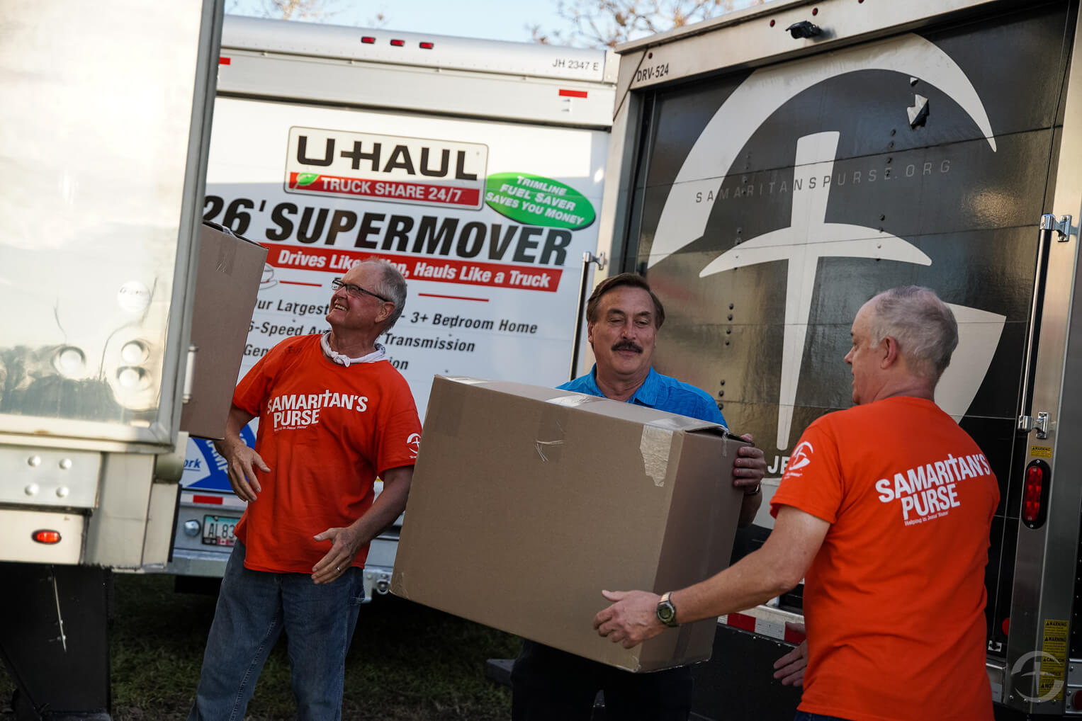 Mike Lindell assists volunteers in unloading boxes of pillows.