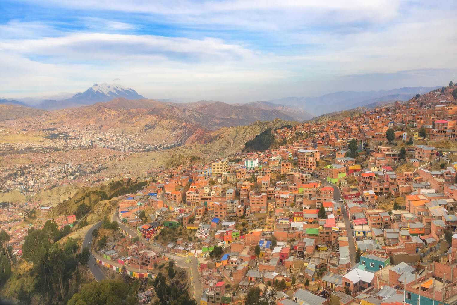 The city of El Alto overlooks the larger La Paz and the high altitude Andean peaks.