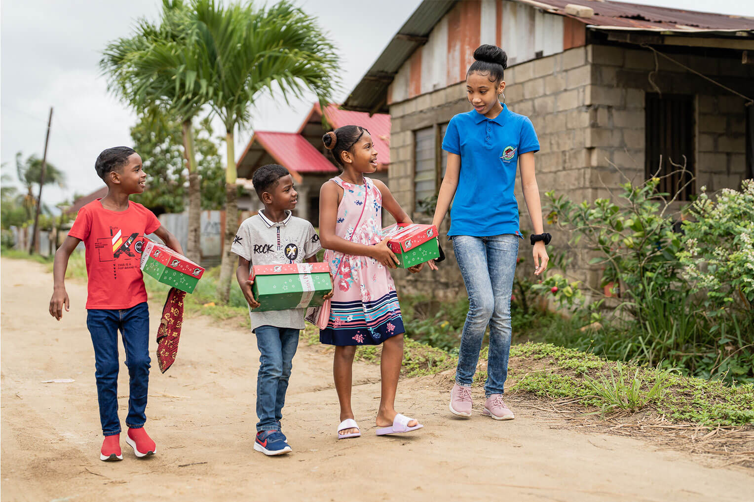 Charahja walks and talks with children who received Operation Christmas Child shoebox gifts in Suriname. 