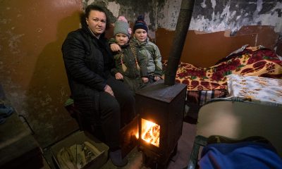Family huddles by Samaritan’s Purse wood stove.