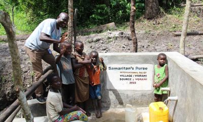 Children enjoy the first cans full of water from their village’s protected water point.