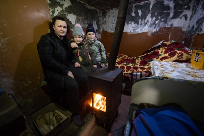 Olena and her children huddle in their cellar next to a stove provided by Samaritan's Purse.