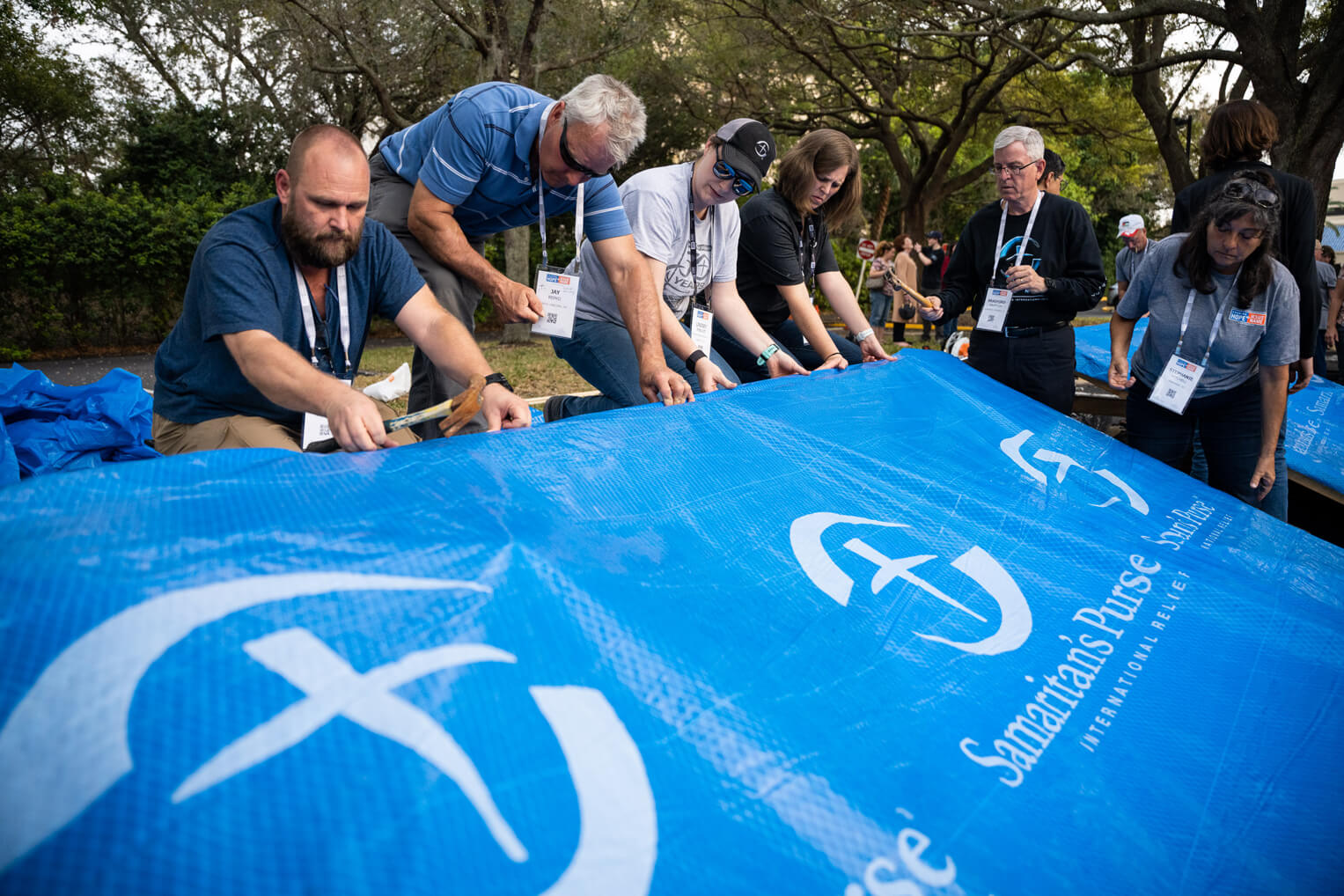 Conference attendees learn how to tarp a roof on a simulated structure.