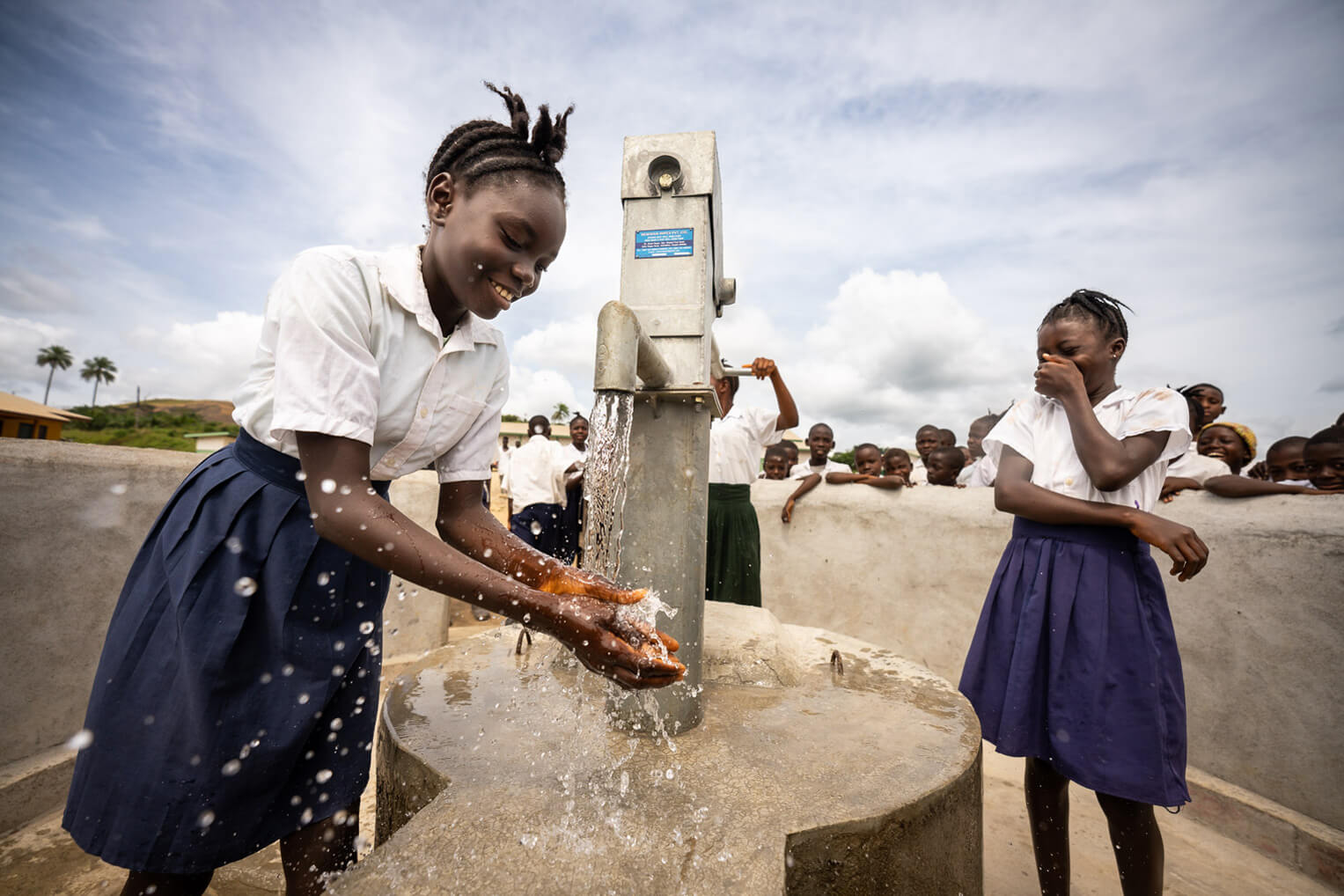A student at a school in Lofa County, Liberia, is enjoying clean water from a newly-constructed well provided by Samaritan's Purse.