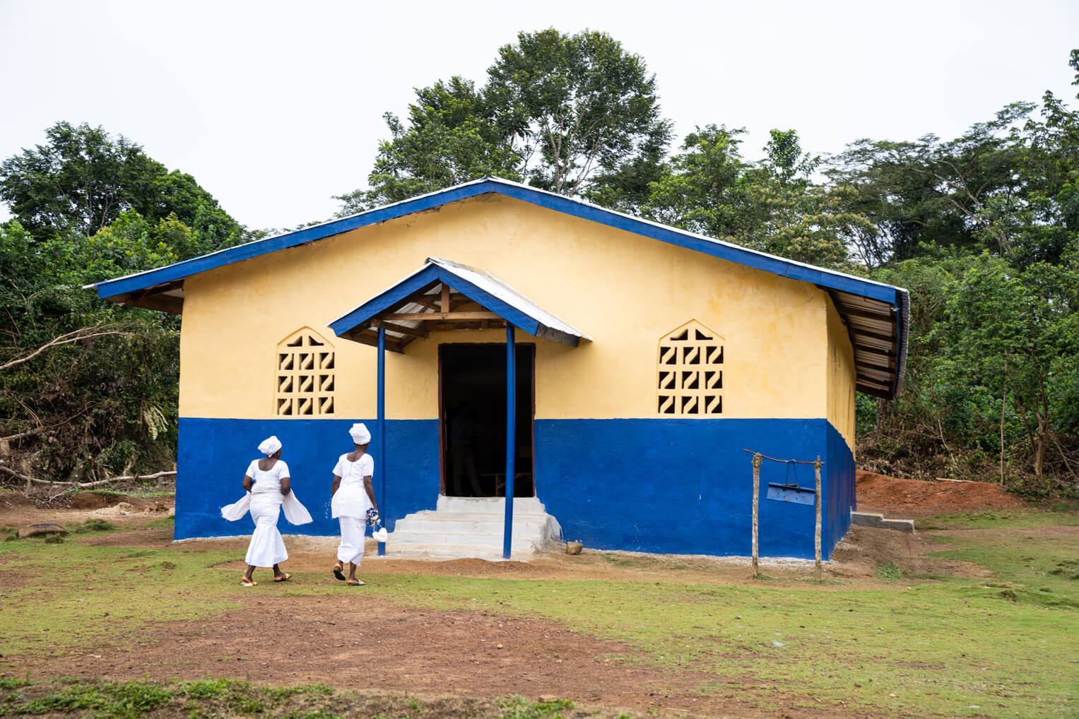 Church members arrive for worship at their newly-constructed building in River Gee.