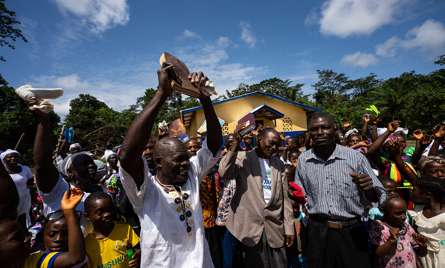 The congregation celebrates God's work in their community and country during the dedication of the new building built by community members