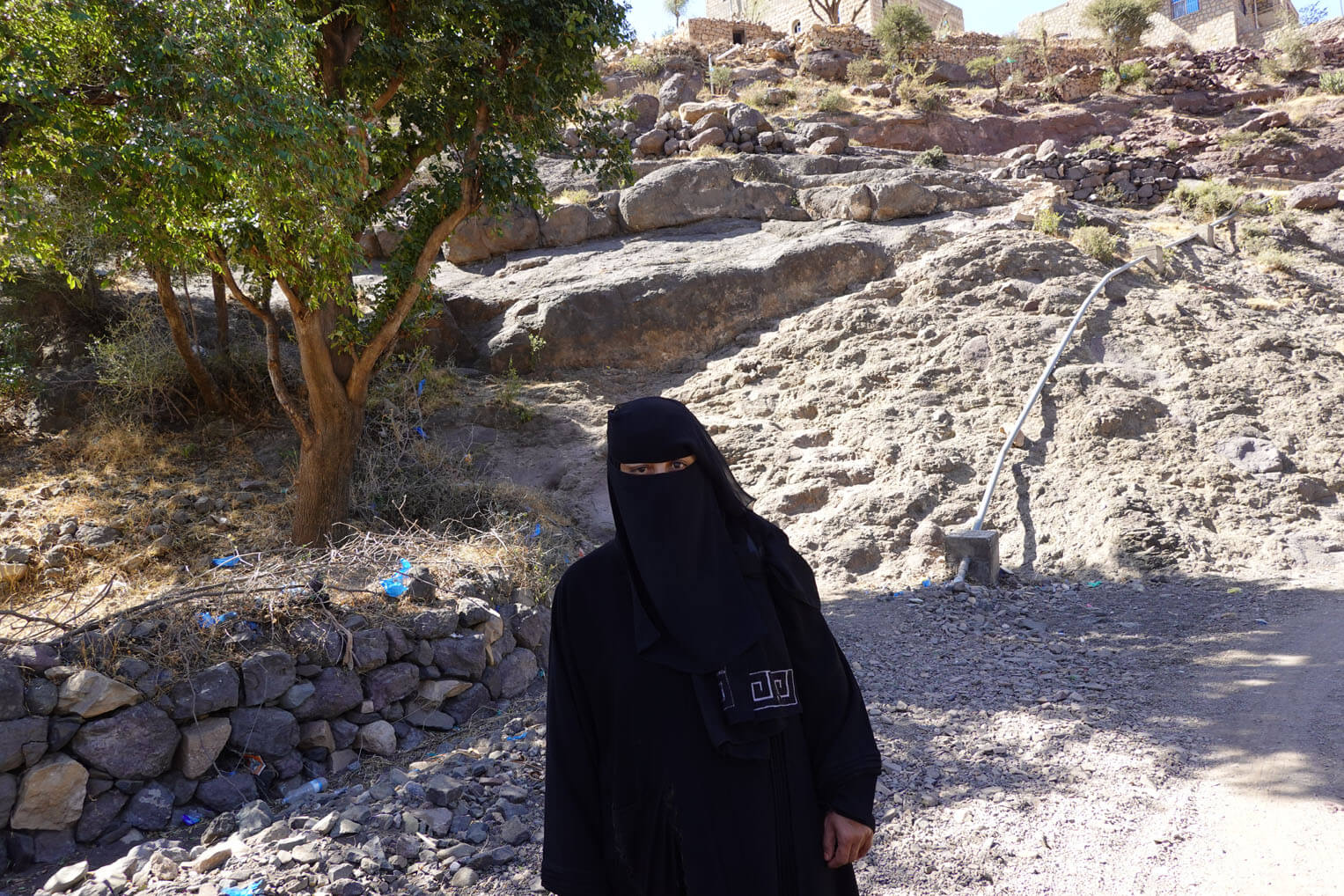Yemeni woman outside with water system