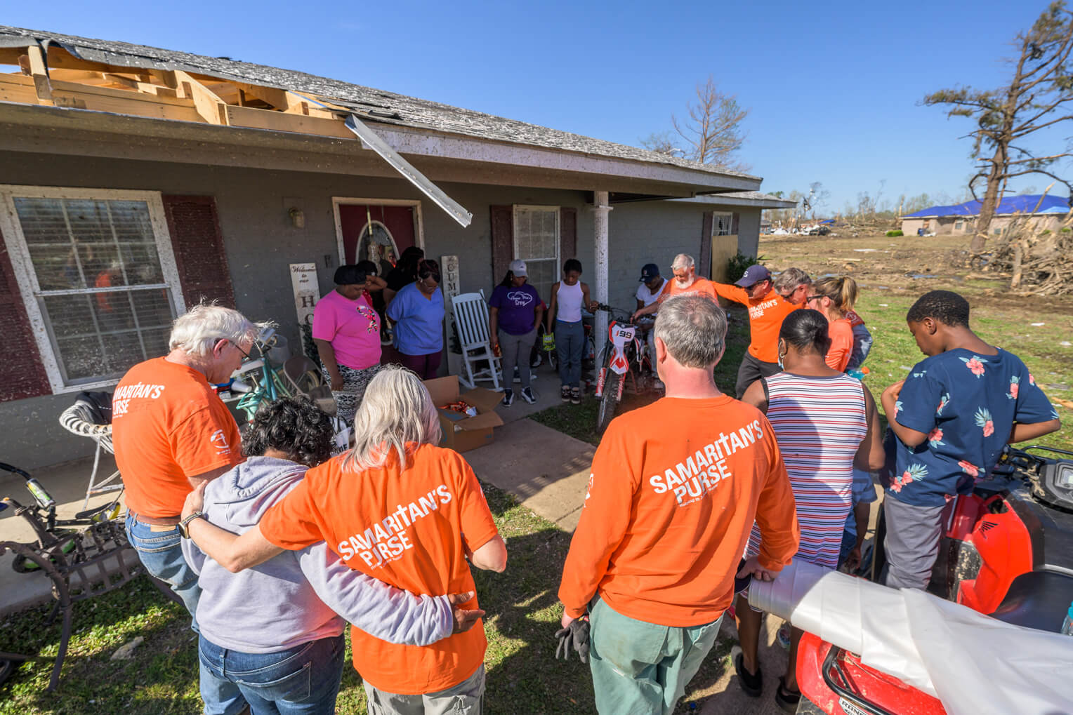 Volunteers gather to pray for a homeowner we helped in Rolling Fork.