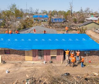 Samaritan's Purse volunteers tarp a home in Rolling Fork.