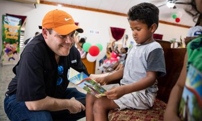 Andy Castillo reads with a young boy at a recent outreach event in Honduras.