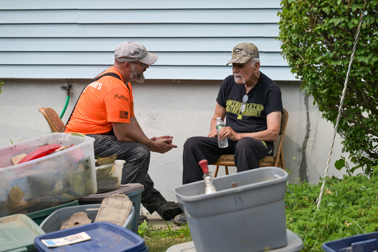 Dexter Bunte shares with a Team Patriot volunteer outside his home.