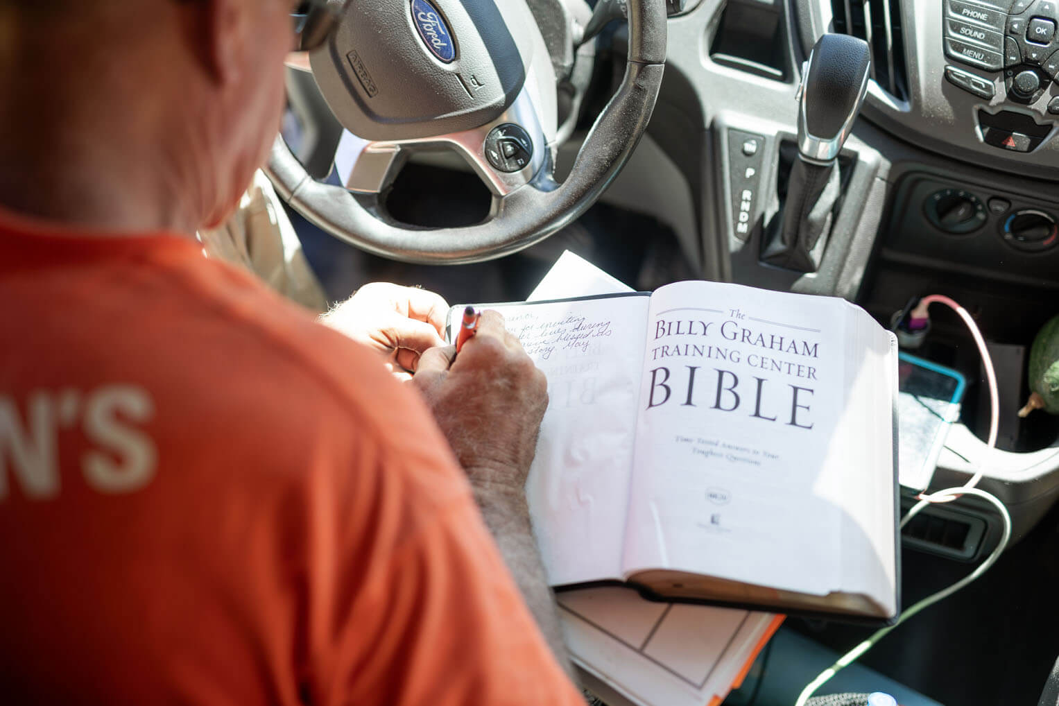 Volunteers signed a special Billy Graham Study Bible to present to the homeowner.